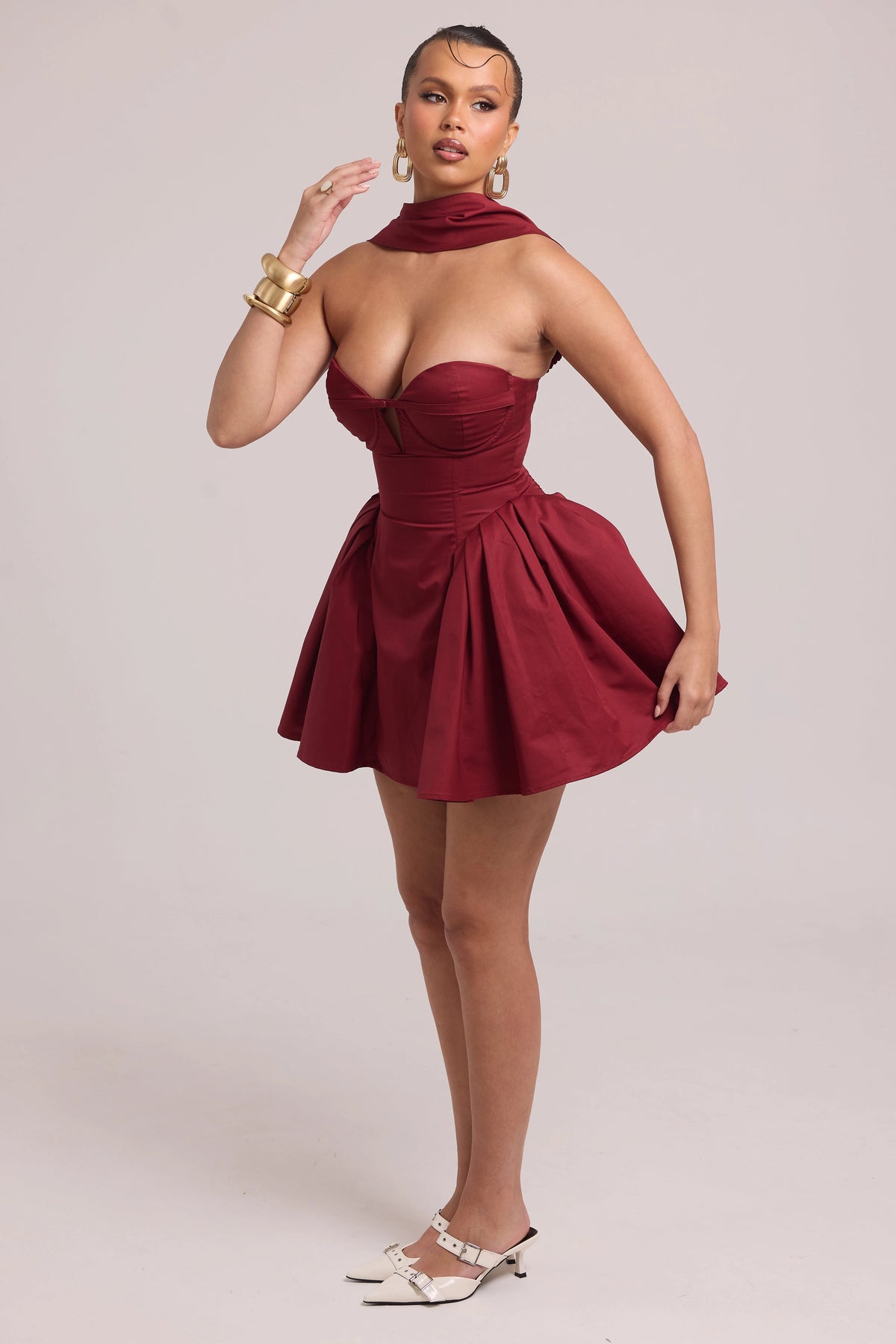 Structured mini dress with fitted bodice and sculptural volume at hips
