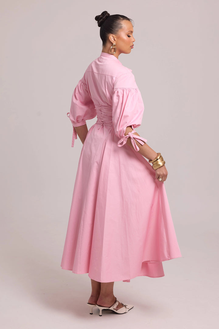 pink shirt dress with shaped seams, full skirt, and lace-up back