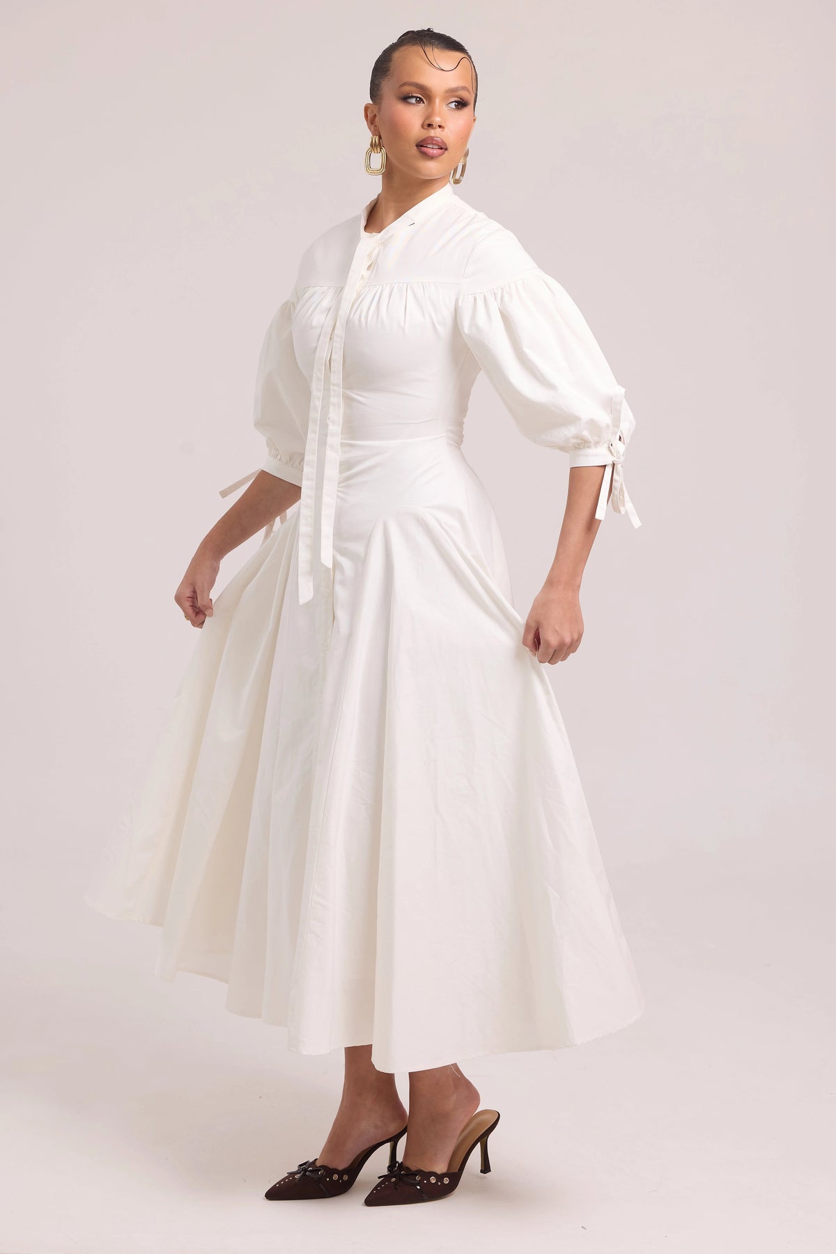 White cotton dress with lace-up back and curved waist cut-out