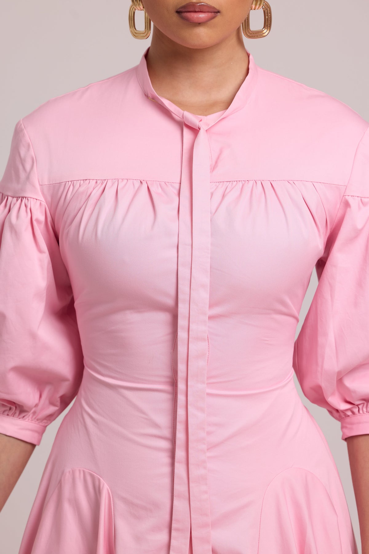 pink button-down shirt dress with voluminous sleeves and fitted waist