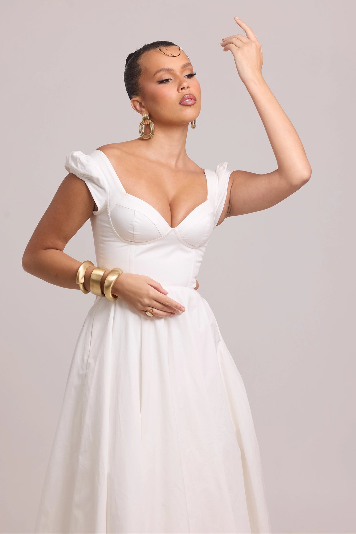 White cotton dress highlighting curved waist cut-out