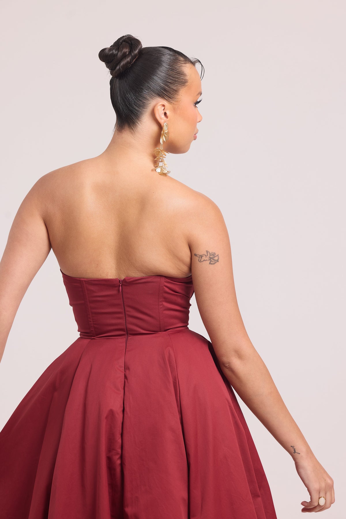 Back view of strapless burgundy midi dress