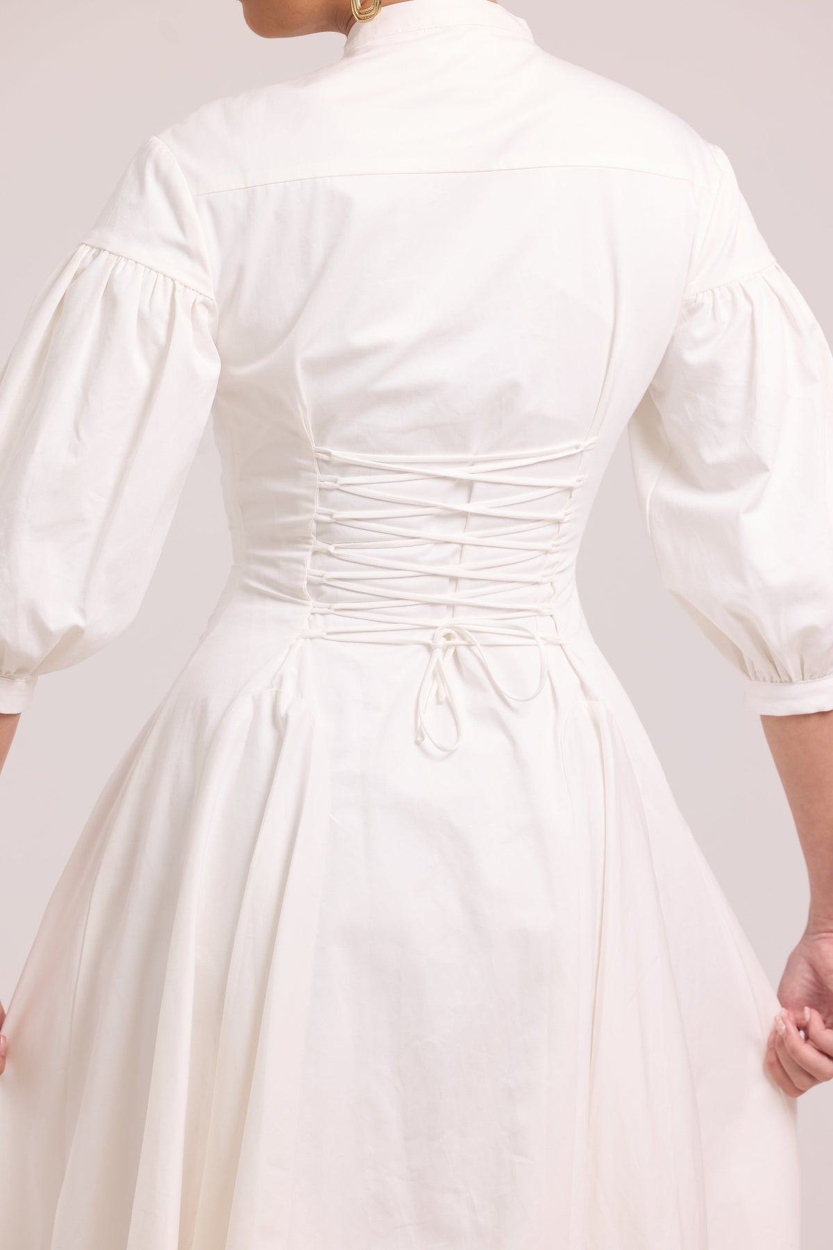 backview of laced up white shirt dress