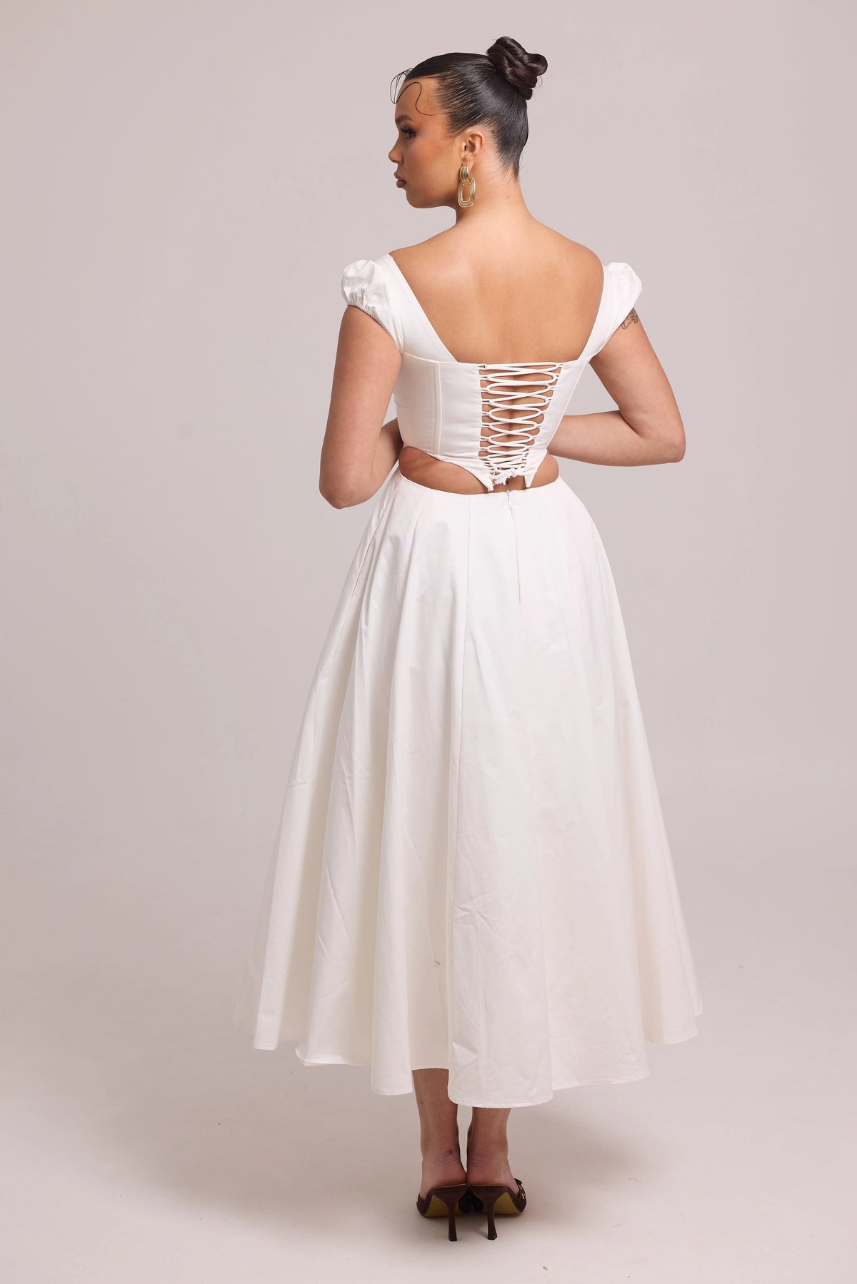 White cotton dress with lace-up back and curved waist cut-out